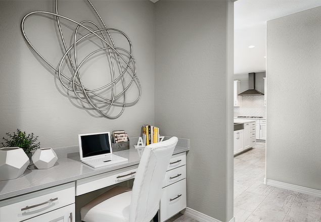 Office nook with built-in desk and white drawers