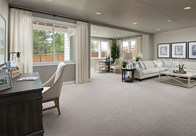 Desk area, sitting area, and dining areas surrounded by windows