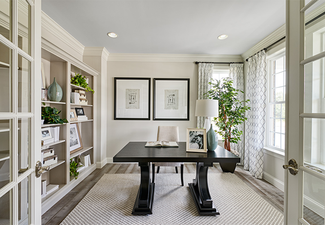 Home office with French doors and built-in shelves