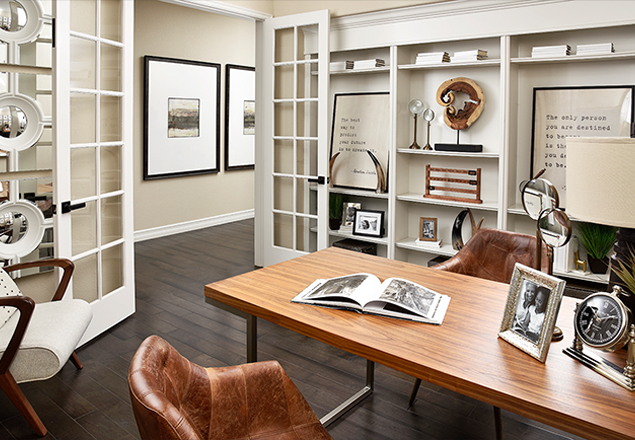 Home office with built-in shelves and French doors
