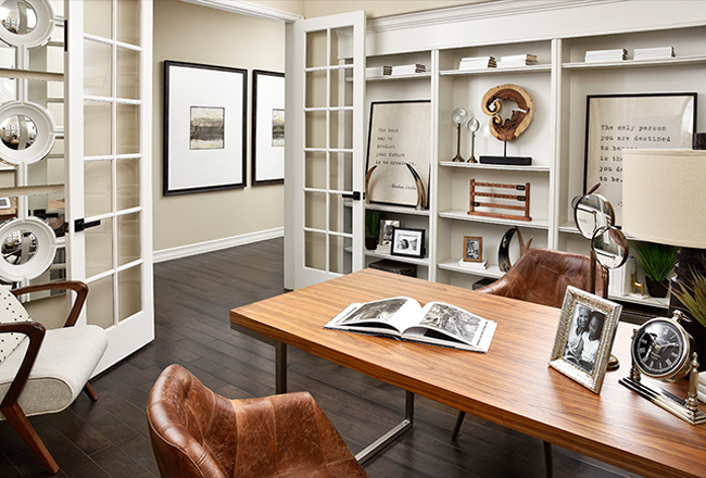 Home office with built-in shelves and French doors