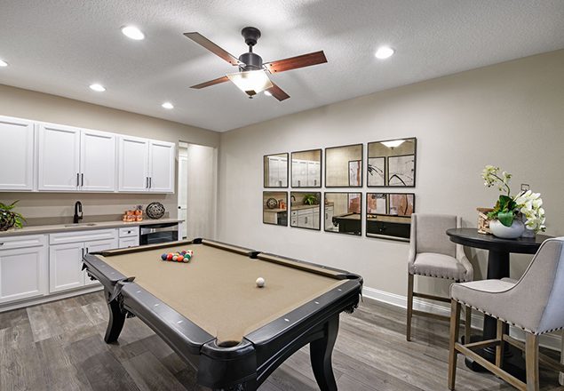 Pool table in front of wet bar