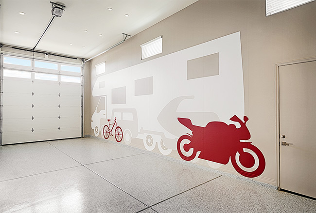 Attached RV garage interior with life-size vehicle decals showing space available
