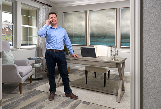 Man standing in study talking on phone