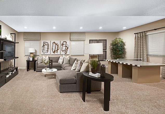 Room with ping pong table and sectional couch