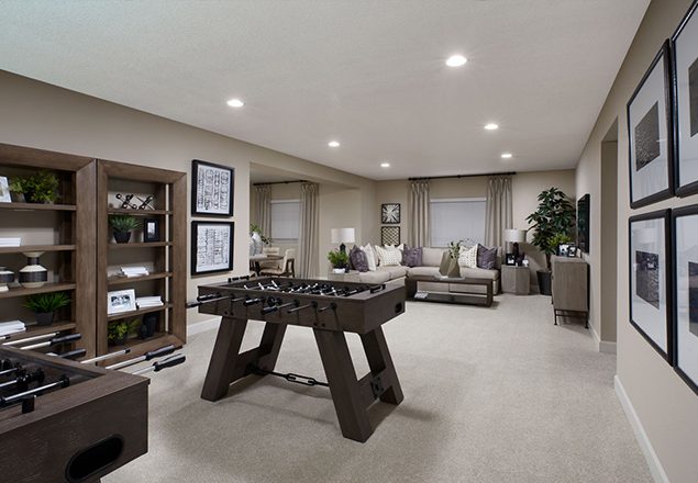 Basement with two foosball tables and sitting area