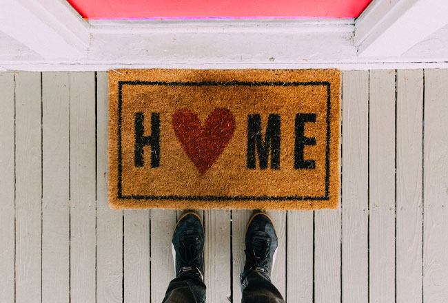 Feet in front of welcome map that says home