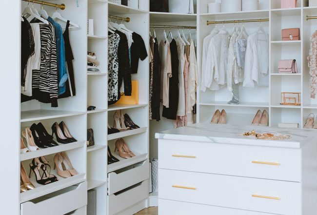 Organized closet with dresser and built-in shelving