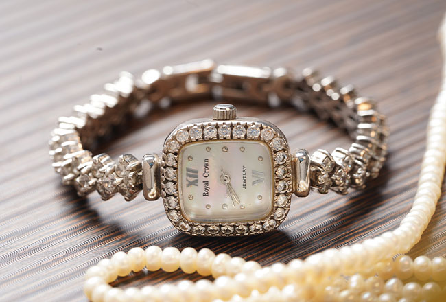 Watch with diamond band and string of pearls