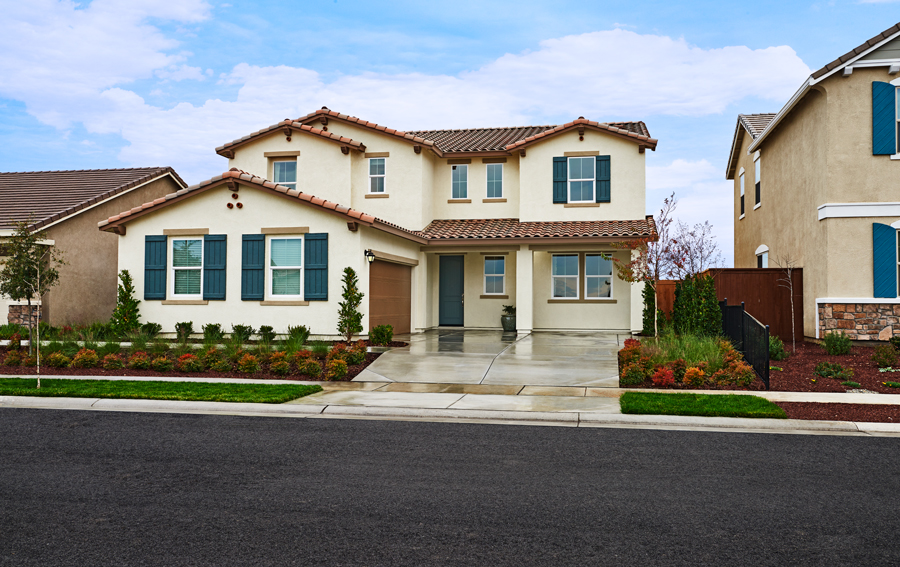 Front of two-story home with side-entry garage and covered porch