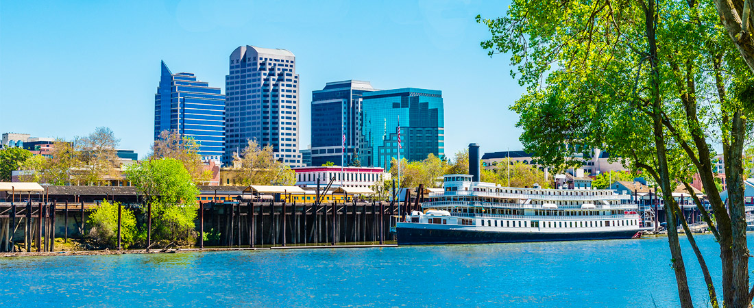 River with boat overlooking Sacramento skyline