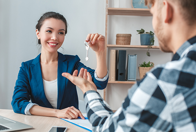 Potential client sitting across table from real estate agent