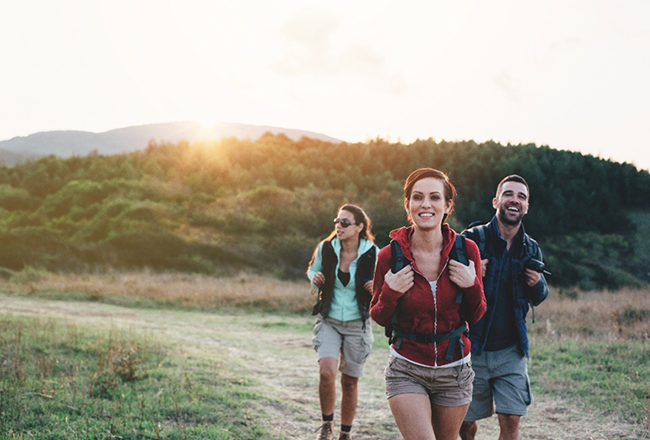 Three people hiking on a trail