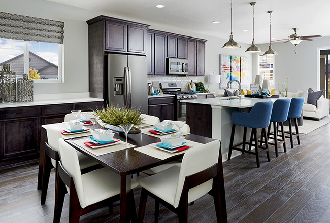 Gourmet kitchen with dark wood cabinets, an island and a dining nook