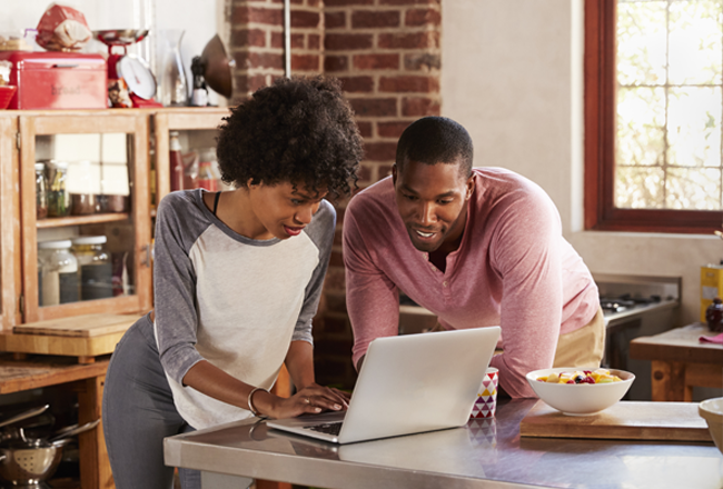 Couple looking at a laptop computer screen