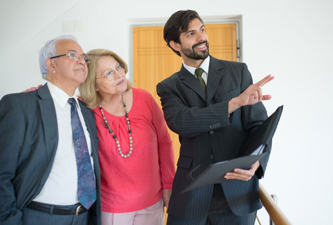 Real estate agent showing a couple a house