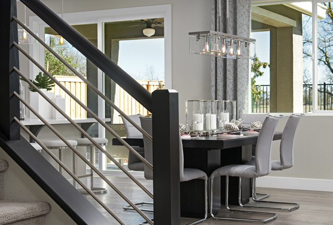 Modern horizontal stair railings overlooking a dining room