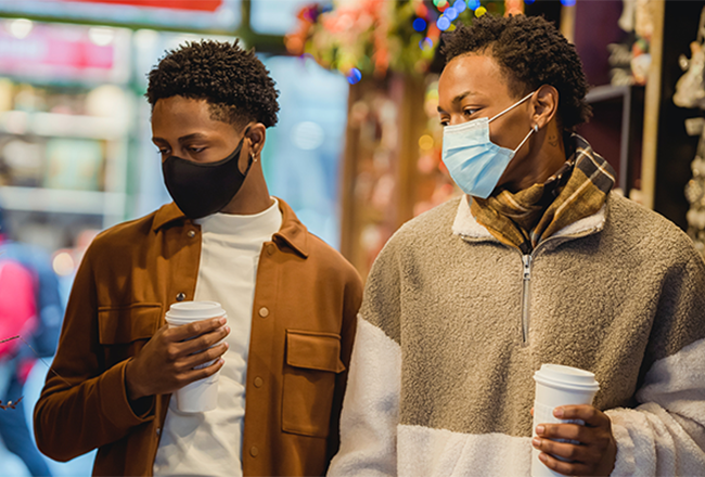 Two men drinking coffee while shopping on Black Friday