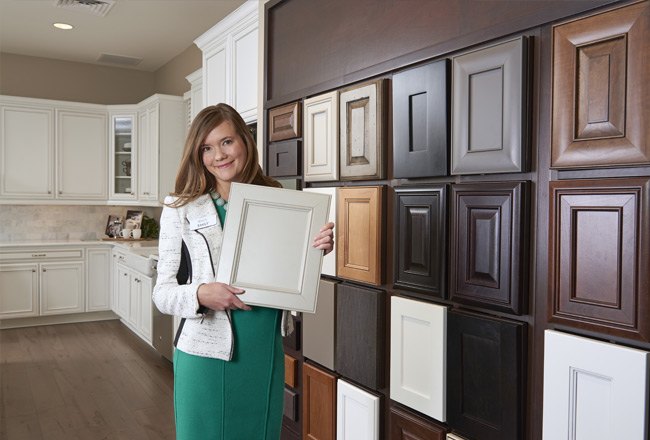 Woman standing in front of display of cabinet door finishes