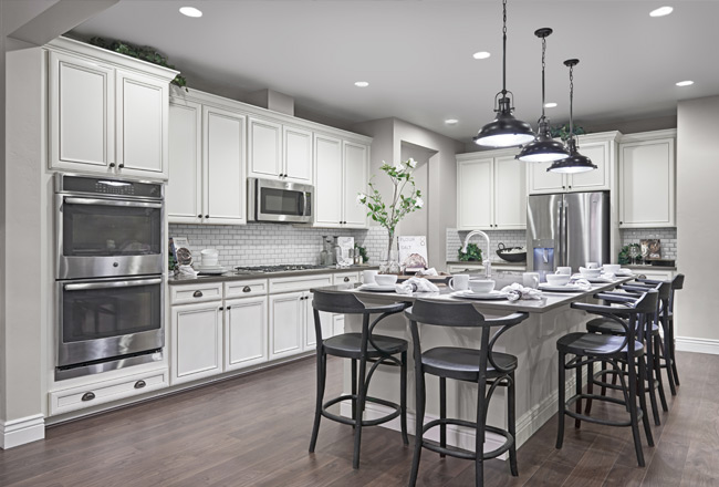 Kitchen with white raised-panel cabinets