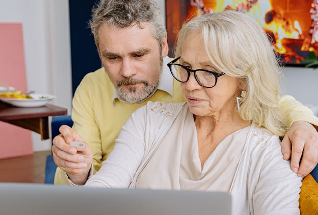 Man and woman reading information on a computer