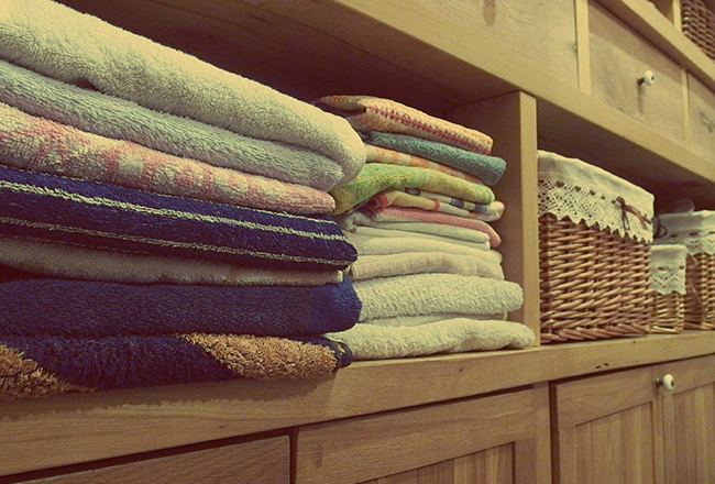 Towels neatly folded on shelf of built-in closet organizer