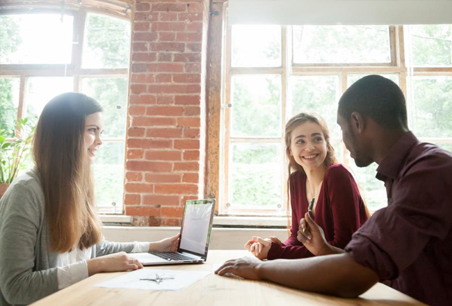 Couple at table meeting with agent