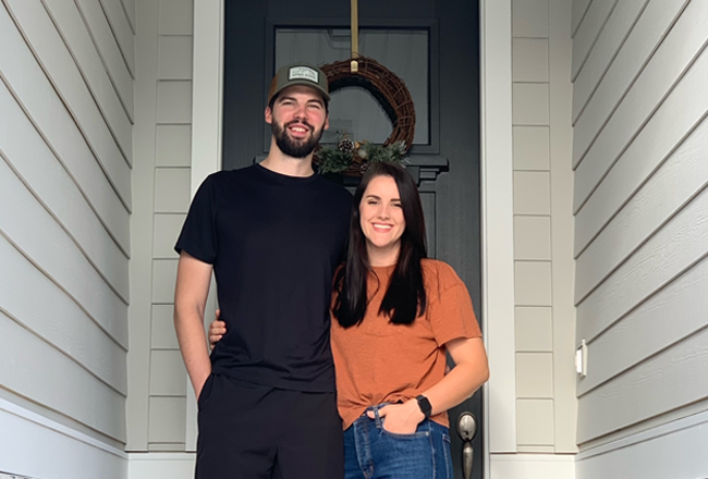 Homebuyers standing in front their front door