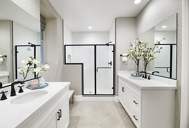 Serene owner's bath with dual vanities and a large walk-in shower