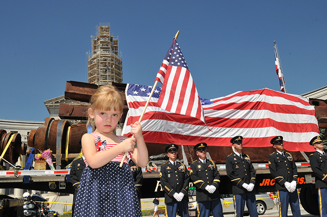 Girl stands in front of World Trade Center steel at Colorado Remembers 9/11, an event The CELL hosted in partnership with the City and County of Denver.