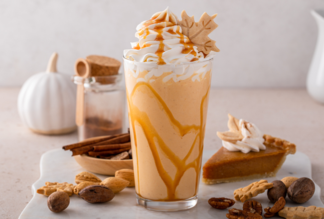 Pumpkin milkshake adorned with maple leaf cookie