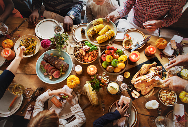 Family gathered around a table, sharing a delicious-looking meal