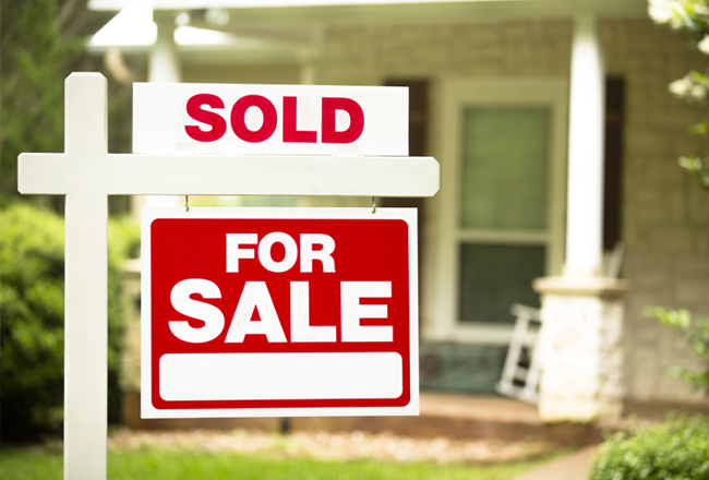 Sold sign in front yard of home