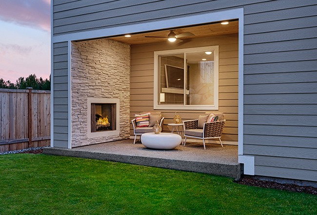 Attached covered patio with a cozy fireplace