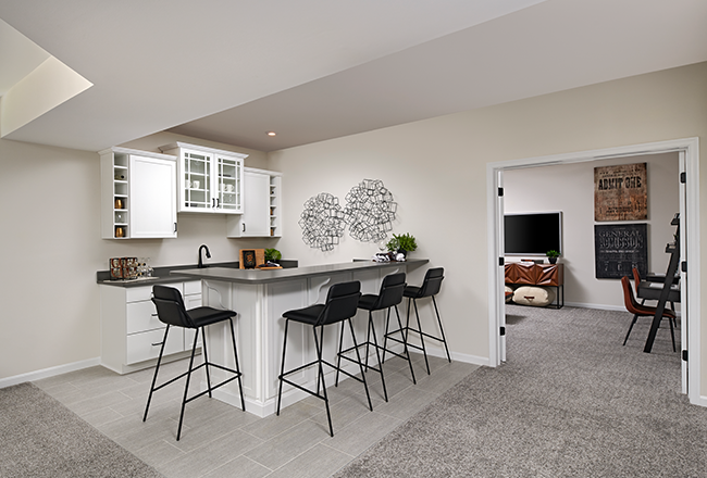 Basement bar with white cabinets