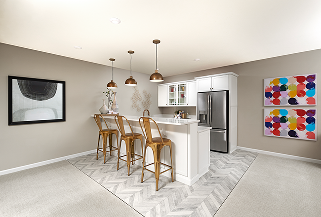 Basement bar with white cabinets and stainless-steel refrigerator