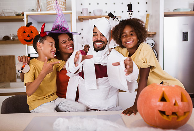 Mother, father, son, and daughter wearing cute Halloween accessories