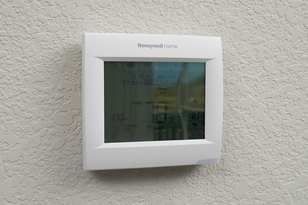 Smart thermostat on a white wall