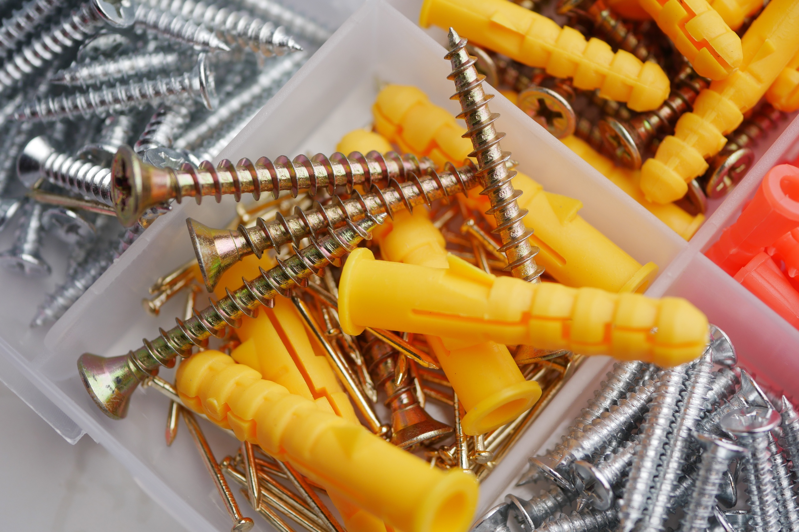 assorted screws in a plastic container