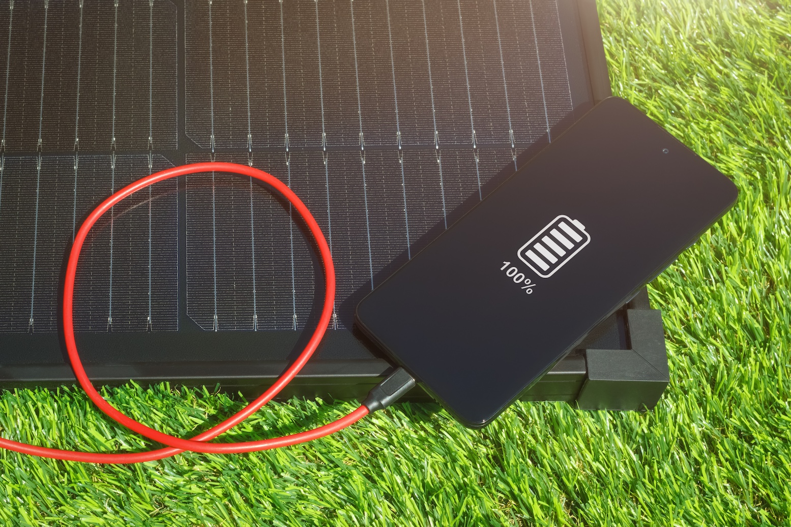 Cell phone plugged into a solar panel