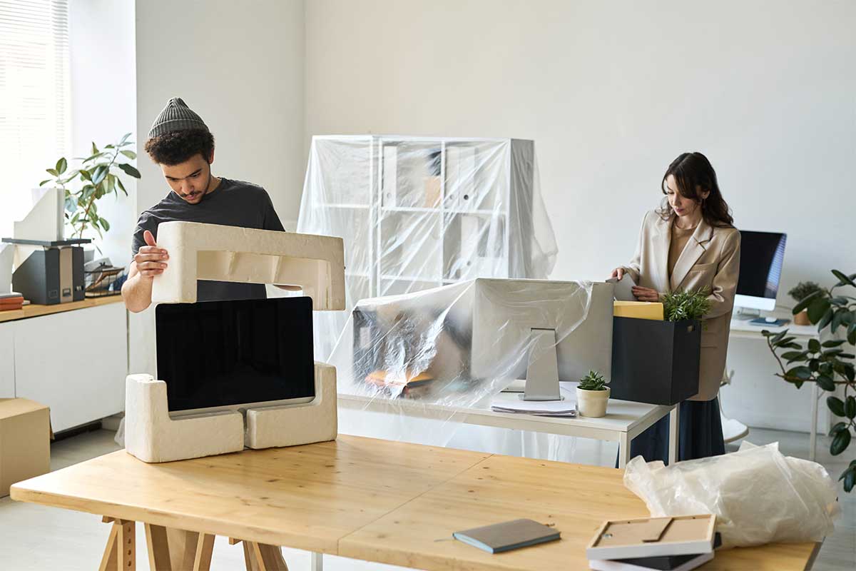 Couple carefully packing their electronics
