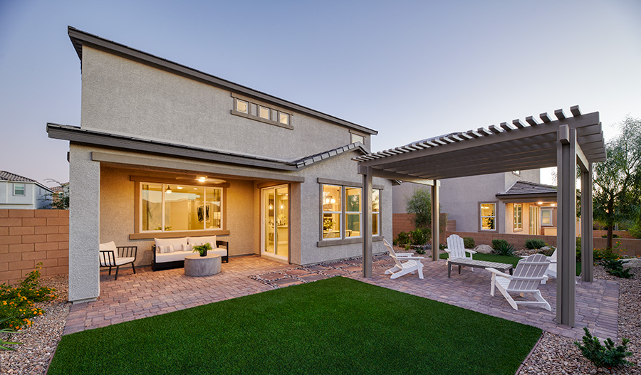 A backyard oasis with a covered patio and an adjacent pergola with additional seating