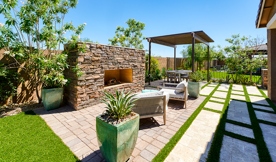 Elegant outdoor fireplace surrounded by cozy chairs