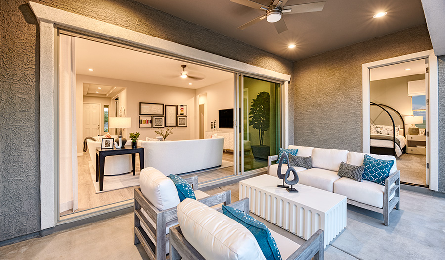 Blue throw pillows and sculpture art decorating a covered patio