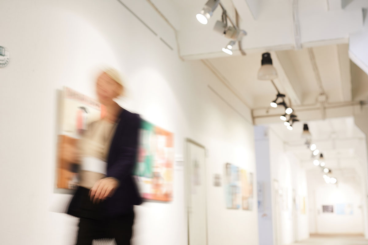 Woman walking through art gallery
