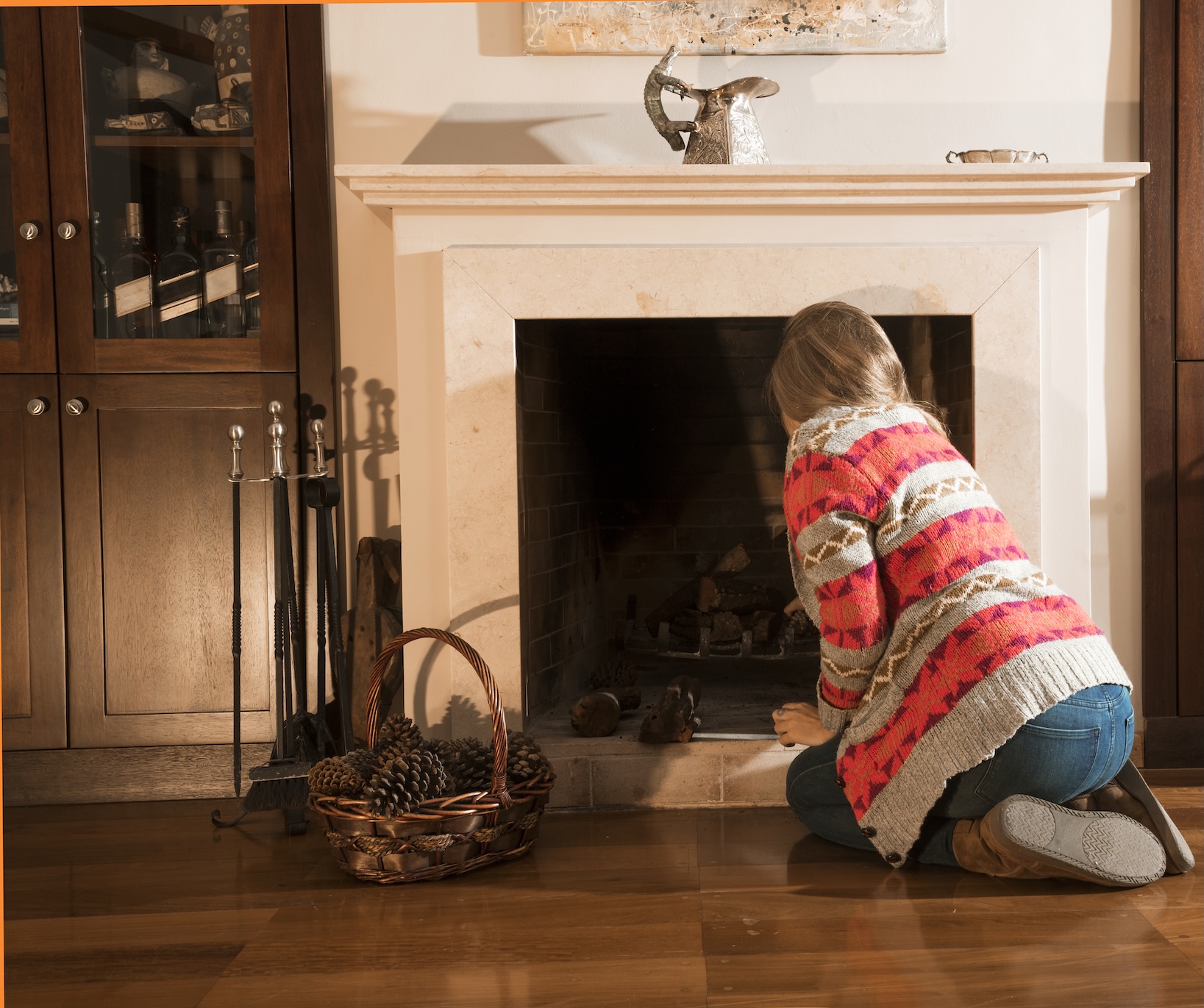 A woman inspecting her fireplace