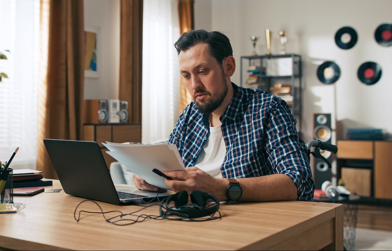A man looking at credit paperwork
