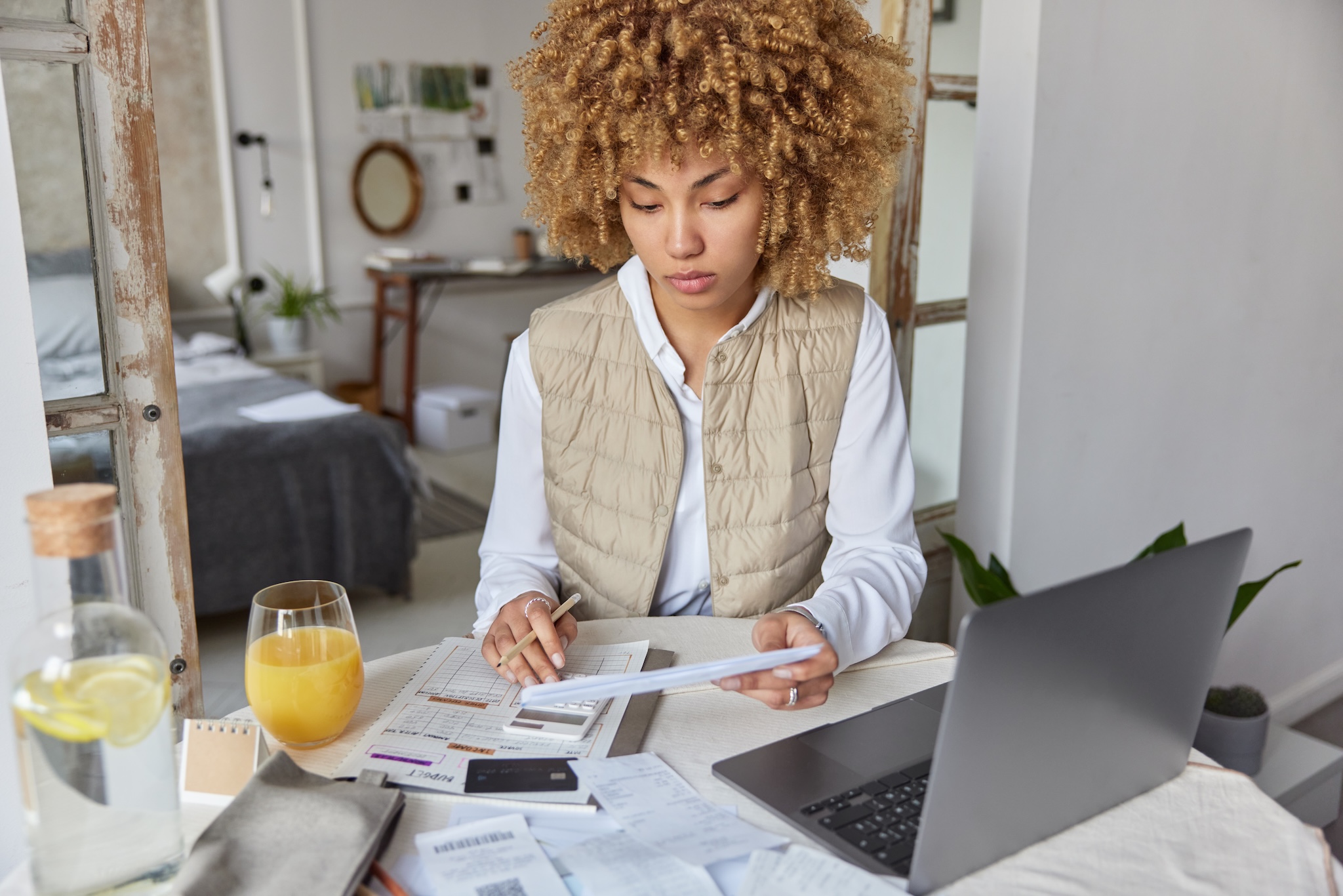A woman looking over bills