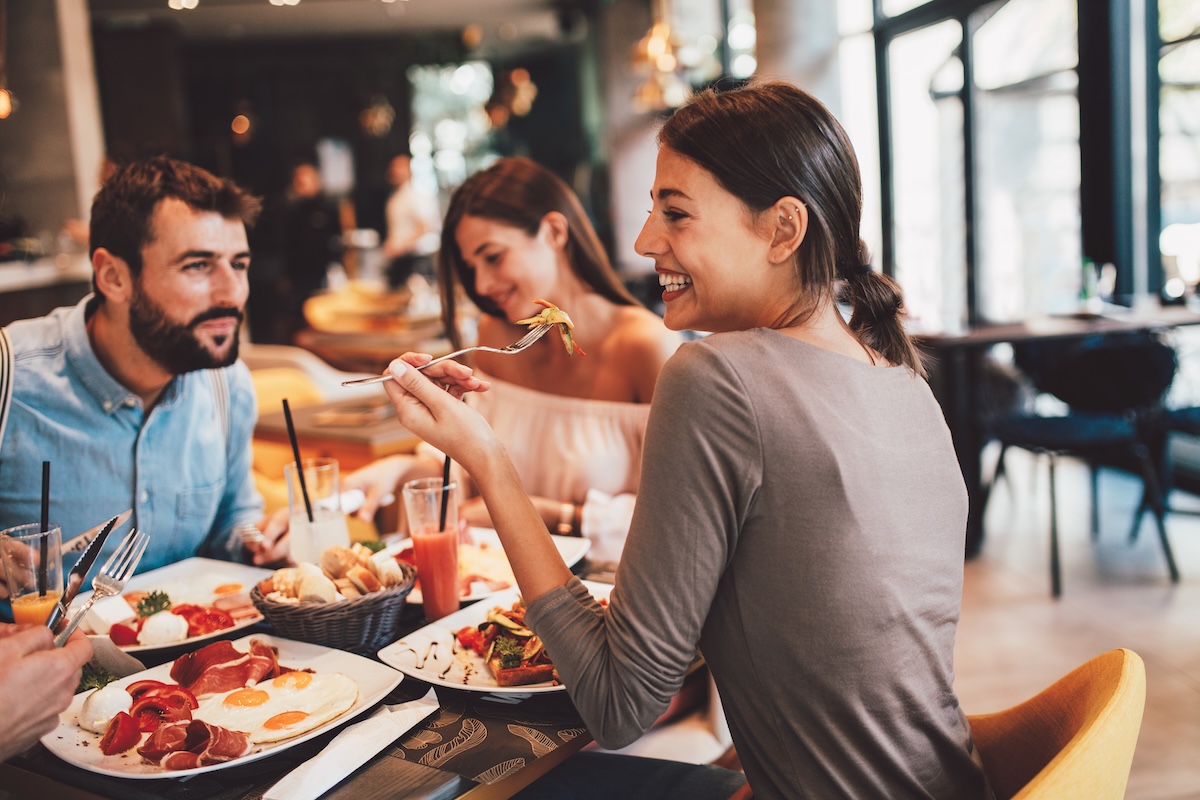 Young adults enjoying a meal at a restaurant