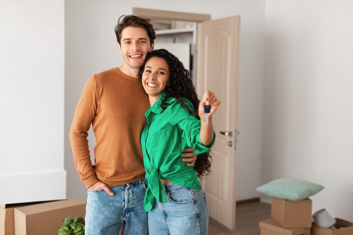 Young couple with the key to their new home
